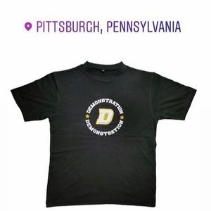 Demonstration black and gold T shirt